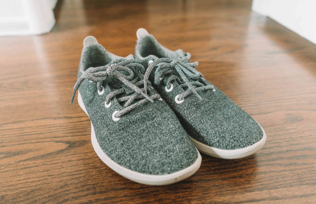 Grey Allbirds Wool Runners from the front three-quarter's view on a hardwood floor
