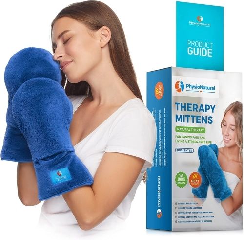 Product photo of 
blue, mitt-like PhysioNatural Microwavable Therapy Mittens, modeled by a woman in a white shirt with light brown hair.