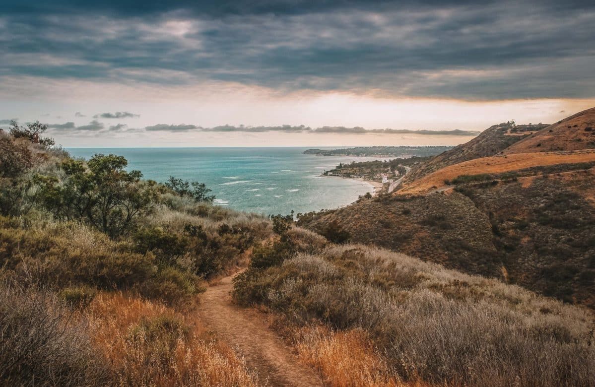 The view of the Pacific Ocean from one of the best Malibu hikes in Malibu, California during a slightly overcast sunset.
