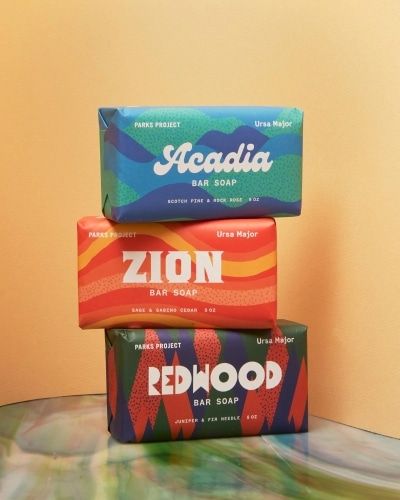 three wrapped national park soaps stacked on top of each other, Redwood, Zion, and Acadia.