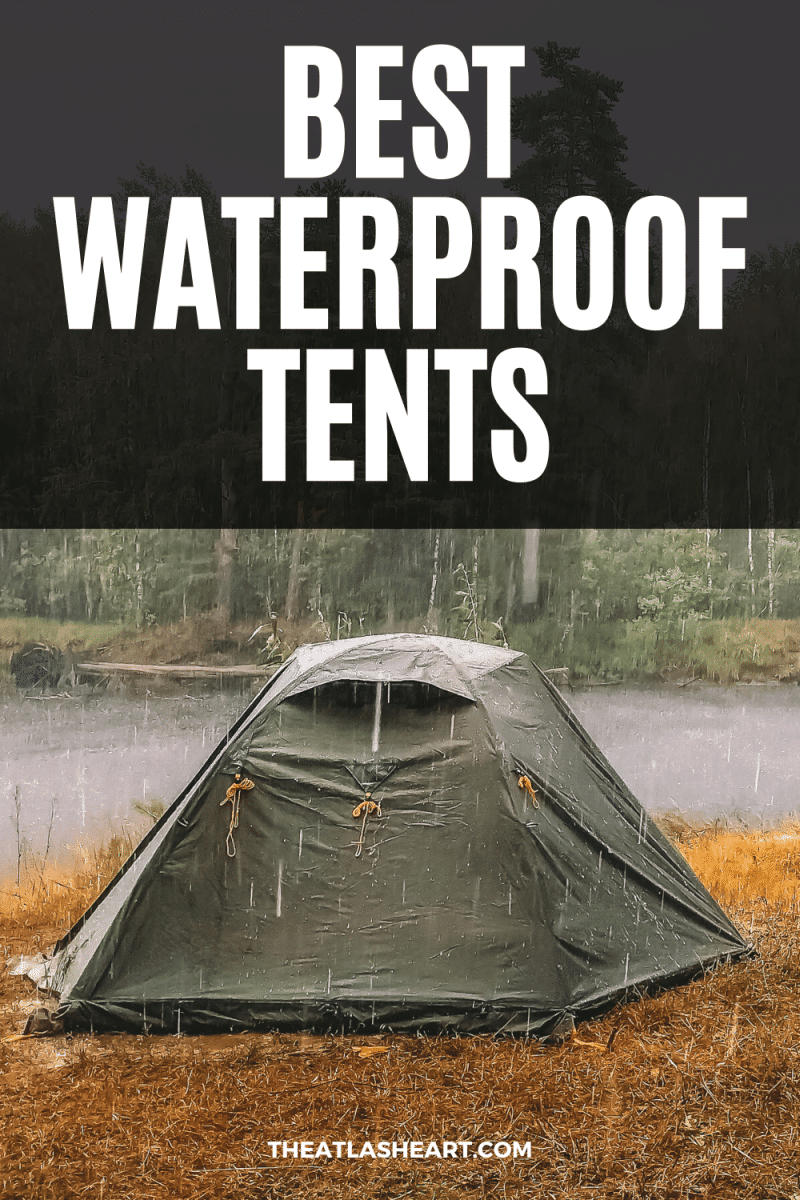 A dark green tent pitched on dry grass on the banks of a river with rain coming down on it, and the text overlay, "Best Waterproof Tents."