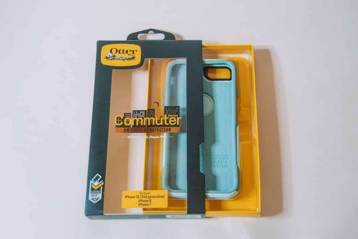 An Otterbox commuter case in partially-opened packaging sitting on a white background.