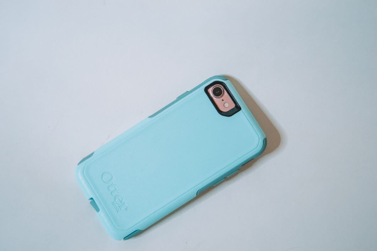 A teal Otterbox Commuter phone case, sitting on a white background.