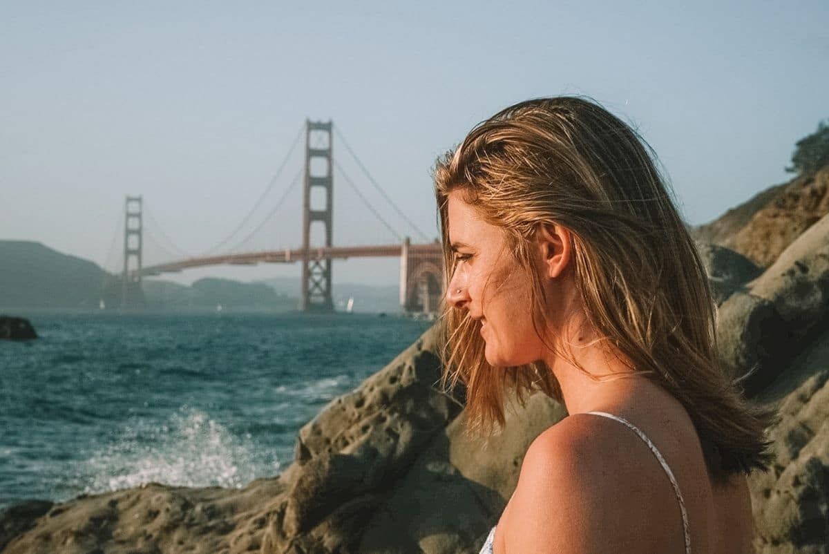 side portrait of a woman with Golden Gate Bridge Background