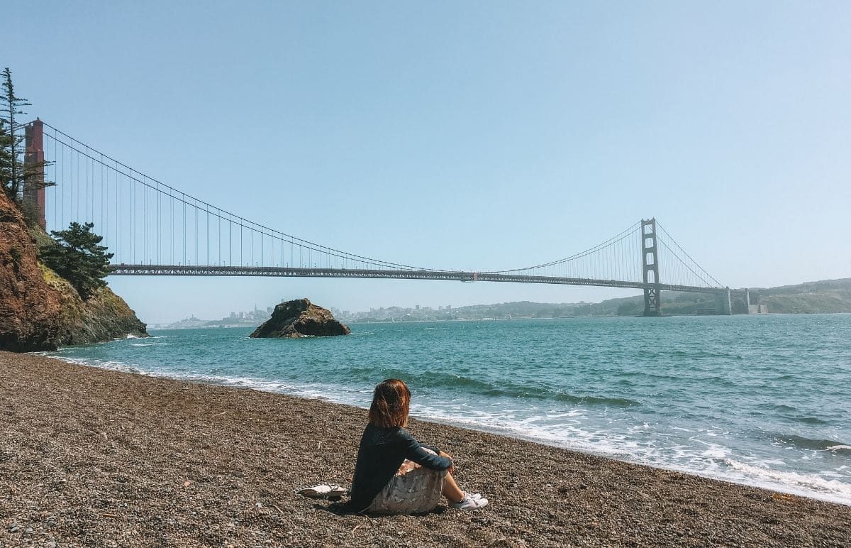 woman at Kirby Beach with the Golden Gate Bridge View