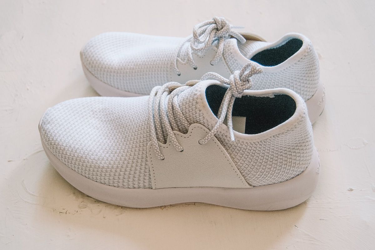A pair of white Vessi Shoes on a white background.