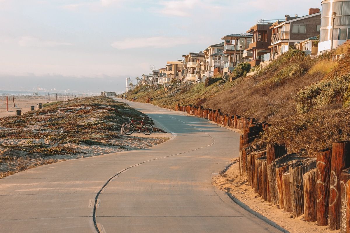 The Strand bike path, which runs alongside the beach, and is lined with ice plants and  beachside houses.