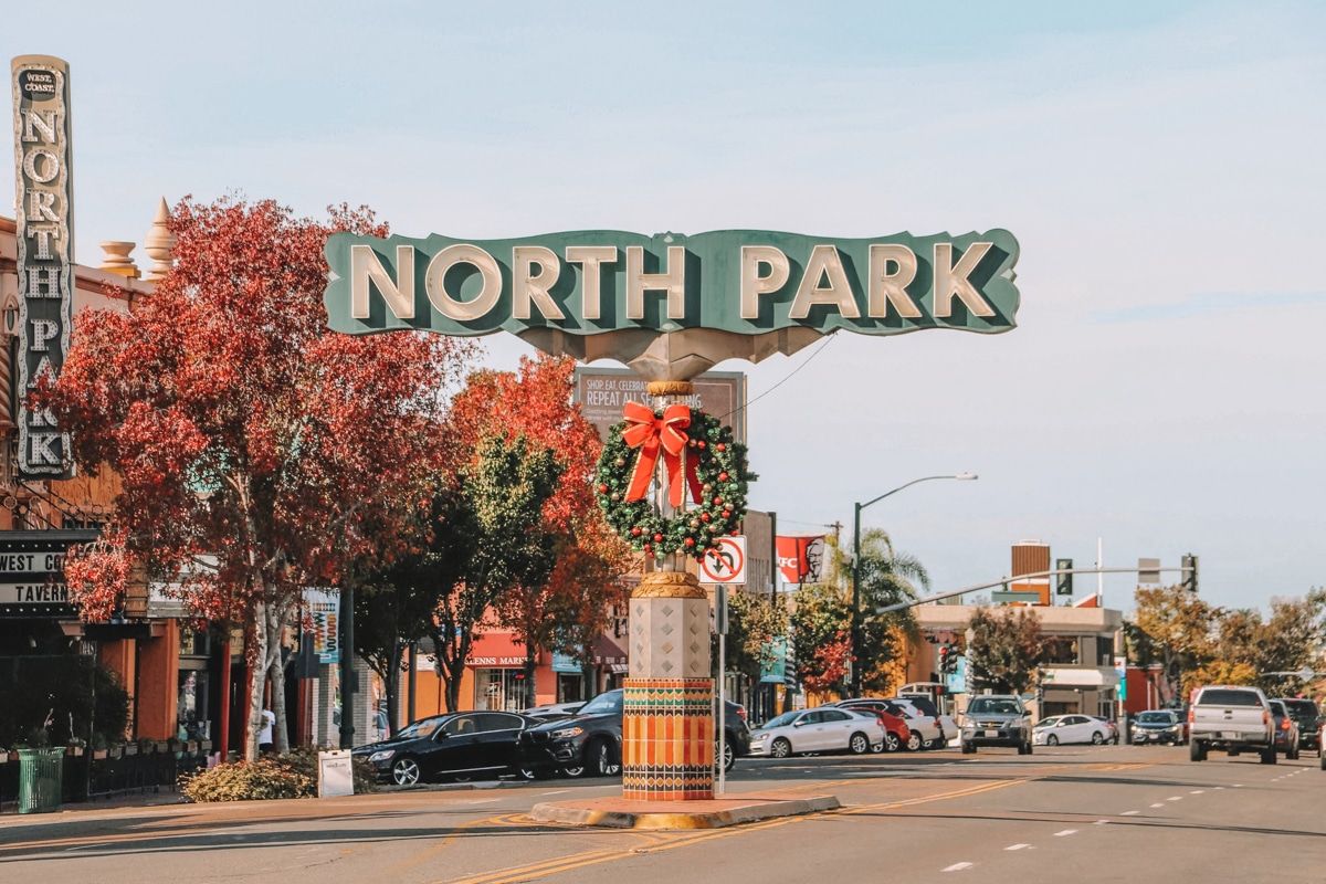 A vintage sign reading "North Park" in the middle of a tree-lined street.