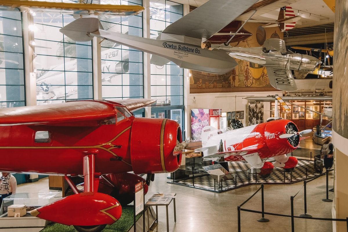 Vintage aircrafts hanging in the airy, spacious San Diego air and space museum.