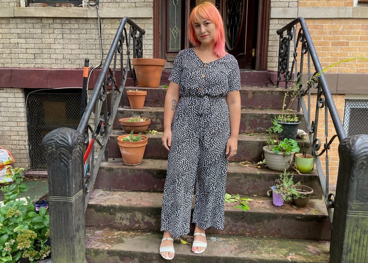 A woman wearing the Emery Rose dalmation print jumpsuit.