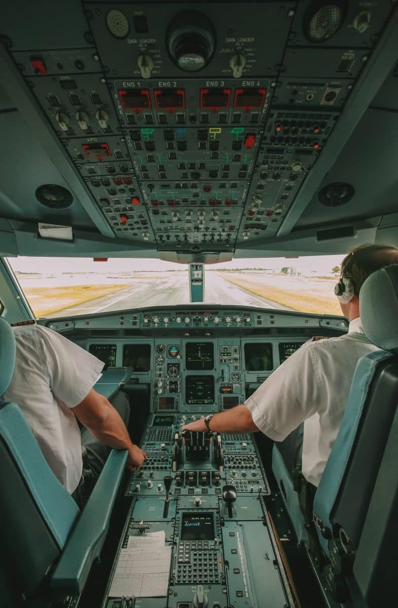 two pilots in airliner cockpit ready to takeoff