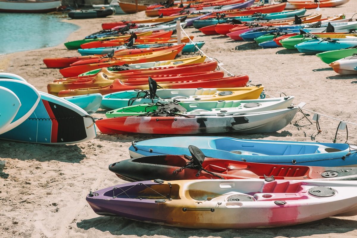 Colorful kayaks on sand