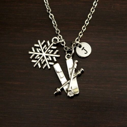 Ski charm product image with two skis, a snowflake, and the letter J in a circle.