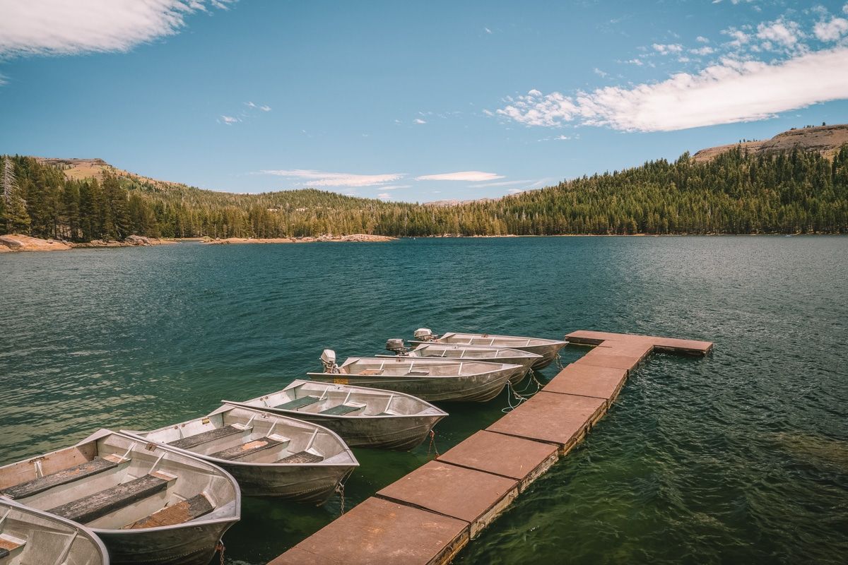 Boats are docked at Lake Alpine, a popular summer camping spot