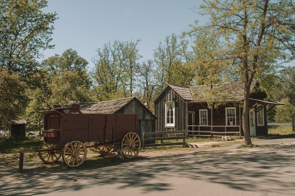 An old wooden wagon parked outside a miner's cabin in Columbia State Historic Park.
