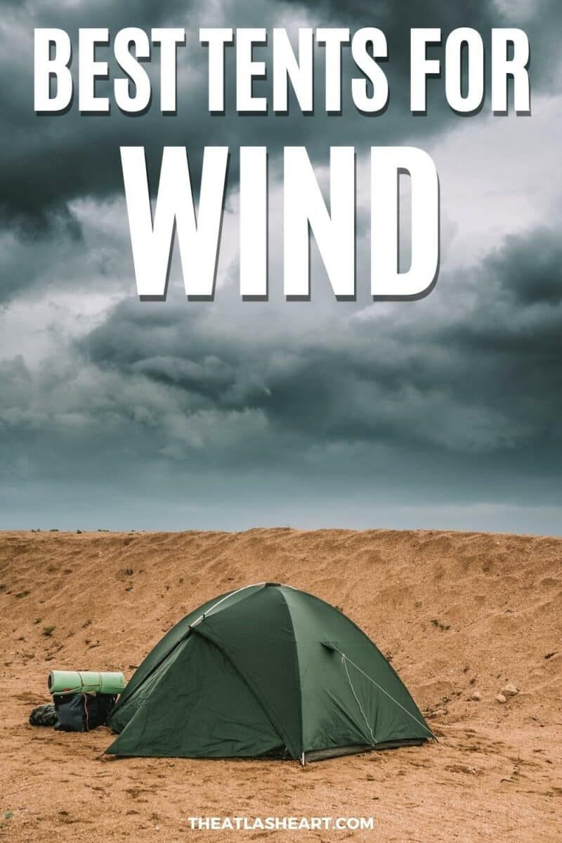 A dark green dome tent, one of the best tents for wind, pitched on the sand with a stormy looking sky overhead, with the text overlay "Best tents for wind."