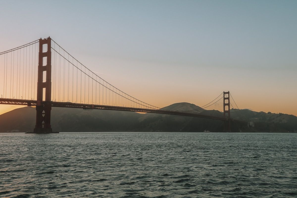 Looking across the water at the Golden Gate Bridge at sunset.