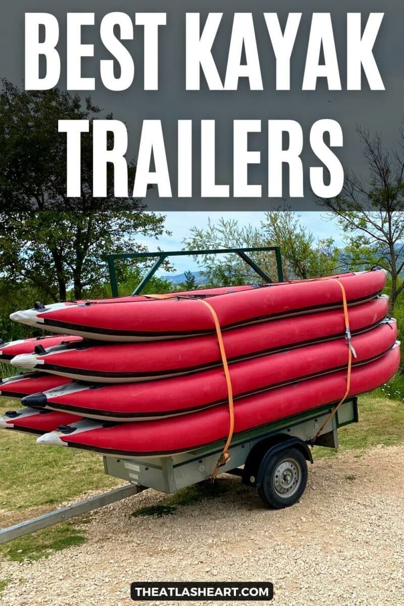 Many red kayaks strapped onto a kayak trailer with the text overlay, "Best Kayak Trailers."