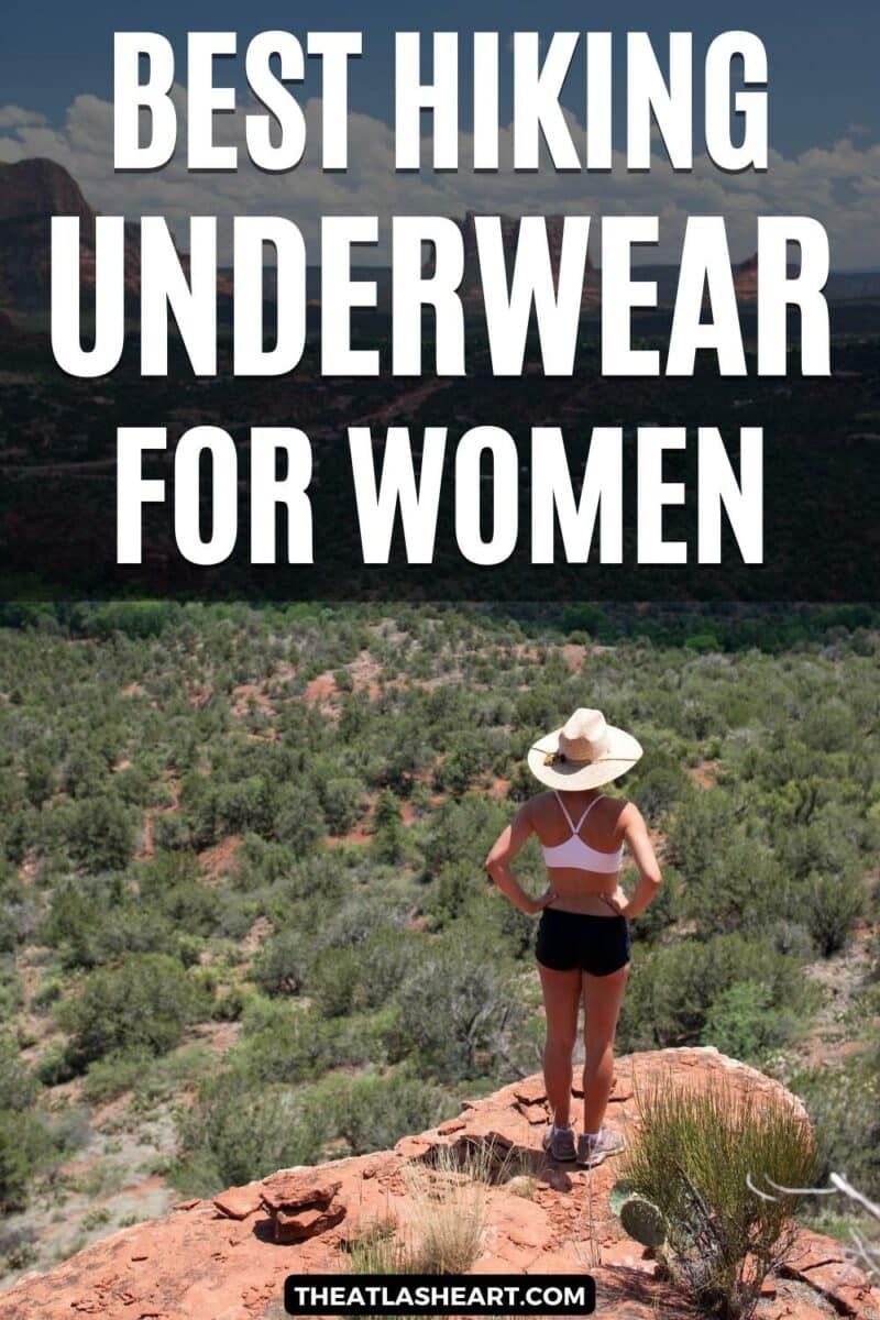 A woman wearing a sports bra, bike shorts, and a cowboy hat stands on a rock looking out at a desert valley, with the text overlay, "Best Hiking Underwear for Women."