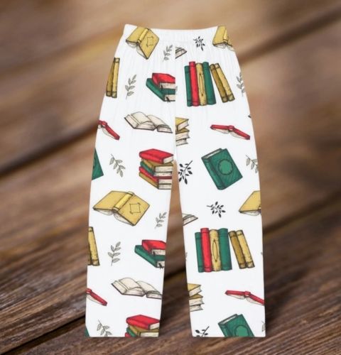 An electronically-created image of white pajama pants decorated in stacks of yellow, red, and green books.