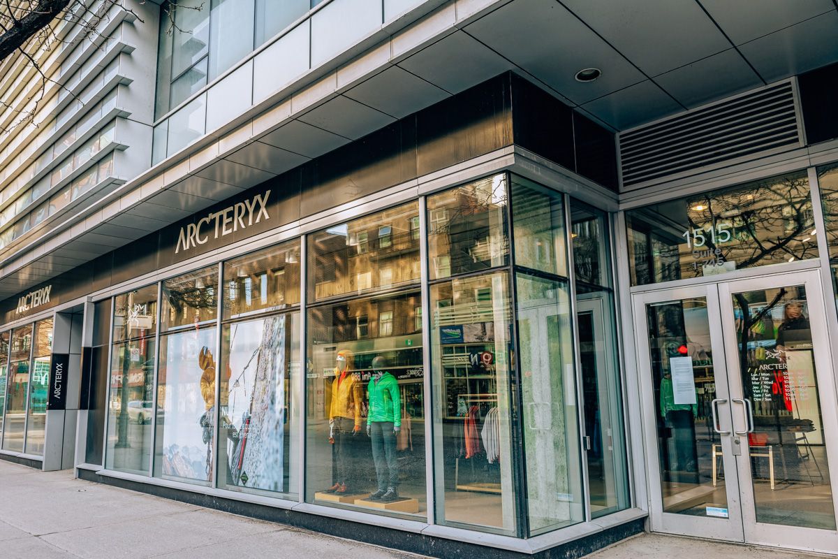 A view from the street of the glass front window of the Arc'teryx storefront.