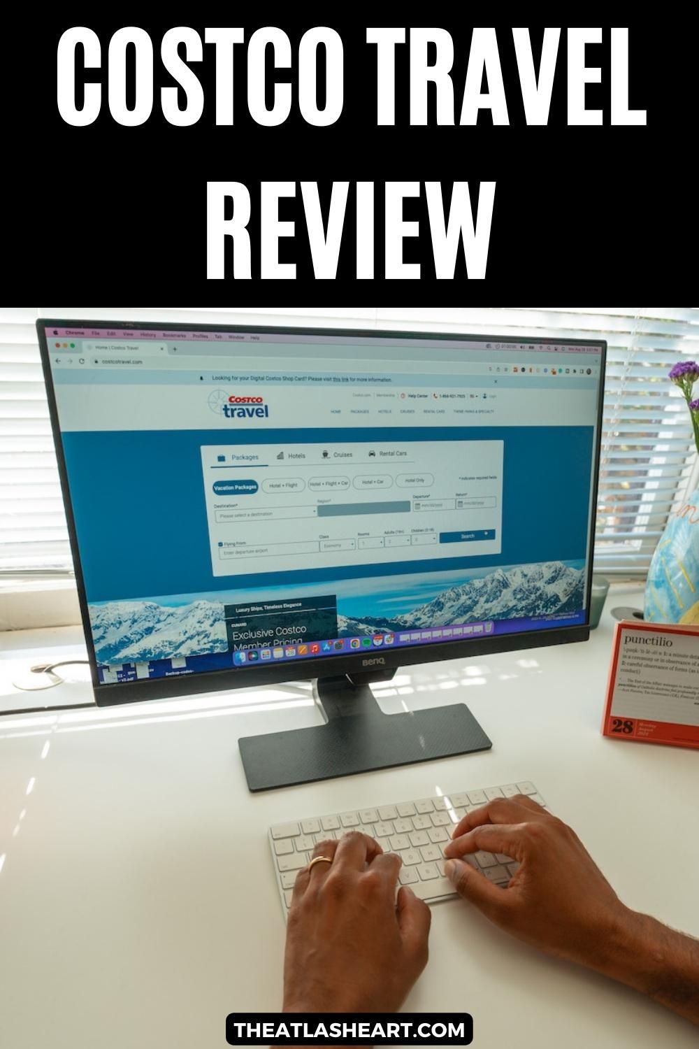 A pair of hands type on a keyboard in front of a monitor displaying the Costco Travel website sitting on a white desk, with the text overlay, "Costco Travel Review."