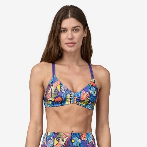 Product image for the Patagonia Reversible Seaglass Bay Bikini Top in a blue tropical print, modeled by a woman with straight brown hair.