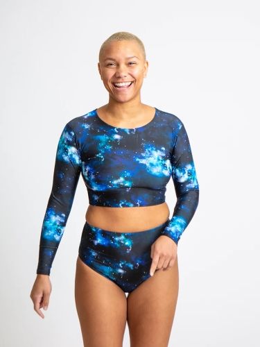 Product image for the Sensi Graves Rose Eco Long Sleeve in blue galaxy print, modeled by a woman with a bleached buzzcut. 