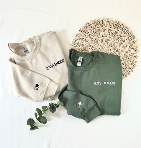 Product image for the Anniversary Embroidery Sweatshirt, pictured in white and green.
