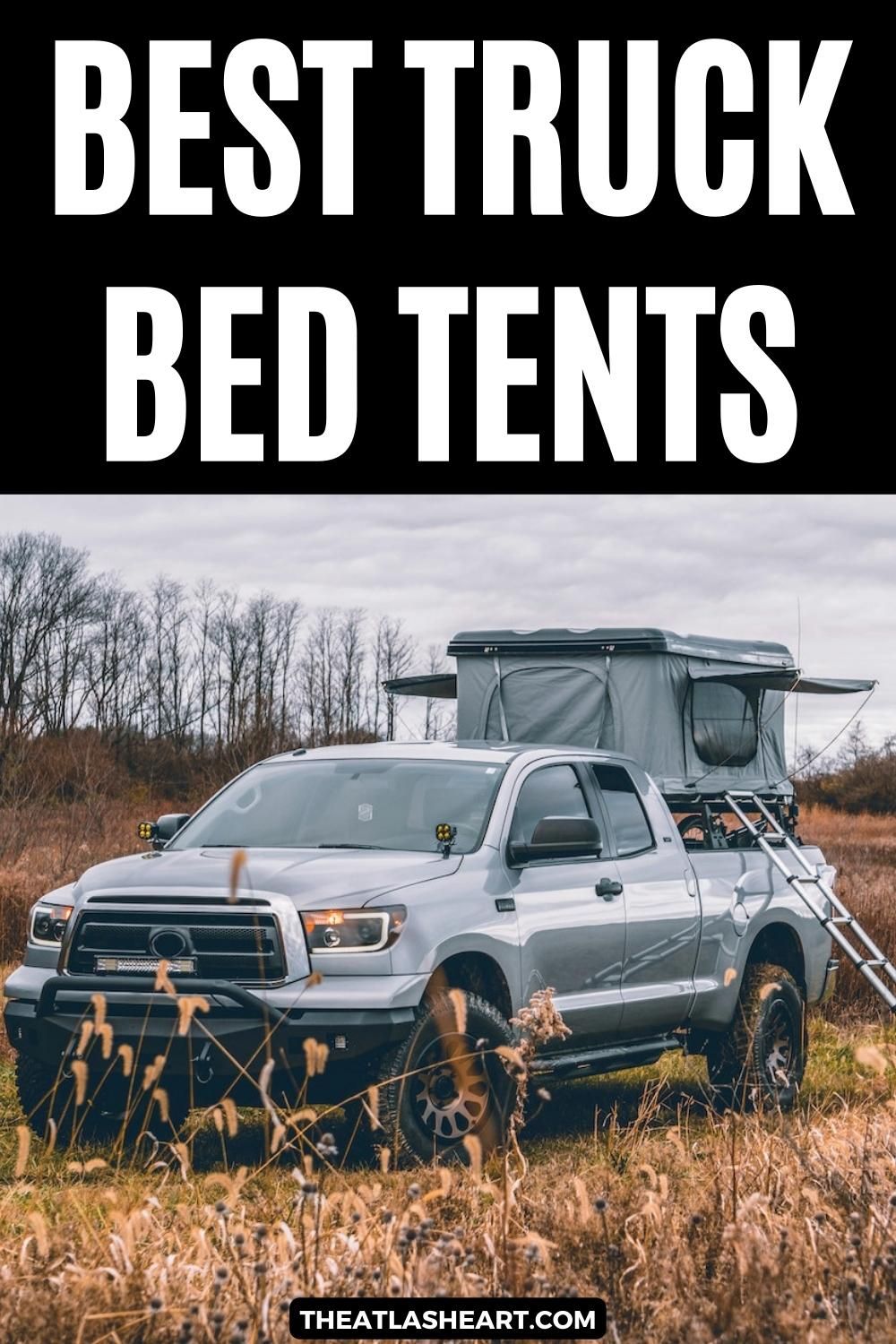 A grey truck with a grey truck bed tent parked ina wintry fieled, with the text overlay, "Best Truck Bed Tents."