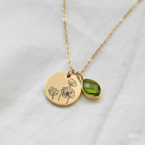 Product image for the gold Carnation Flower Necklace with a green stone. 