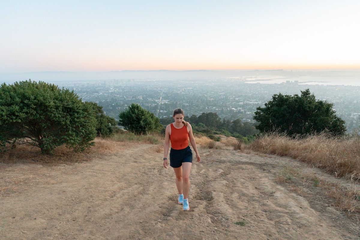 Mimi walking up a hill in her Hoka Clifton 9 Shoes.
