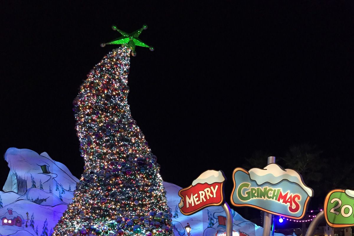 Holidays at Universal Studios
A whimsical Christmas tree reaches for the sky, but has a curvy posture, and stands beside signs that say "Merry Grinchmas."