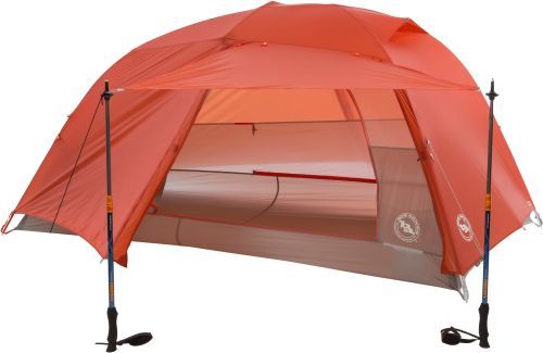 The Big Agnes Copper Spur UL2 backpacking tent in orange and tan with two trekking poles holding up the awning.