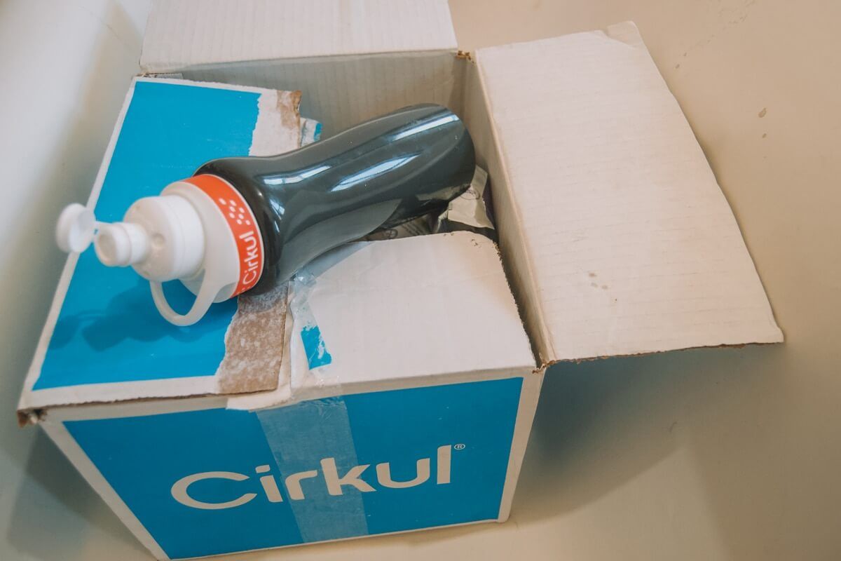 A Cirkul water bottle sitting on top of a half-open blue Cirkul box.