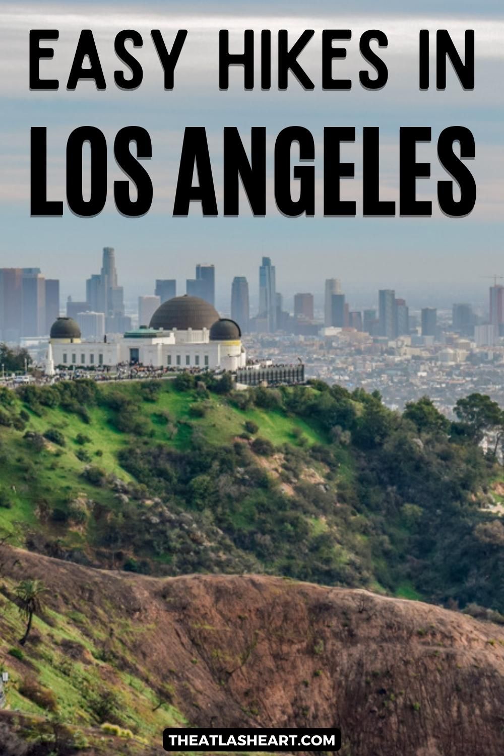 A view of Griffith Observatory on the top of a green hill, with the sprawl of Los Angeles and a hazy sky in the background, and the text overlay, "Easy Hikes in Los Angeles."
