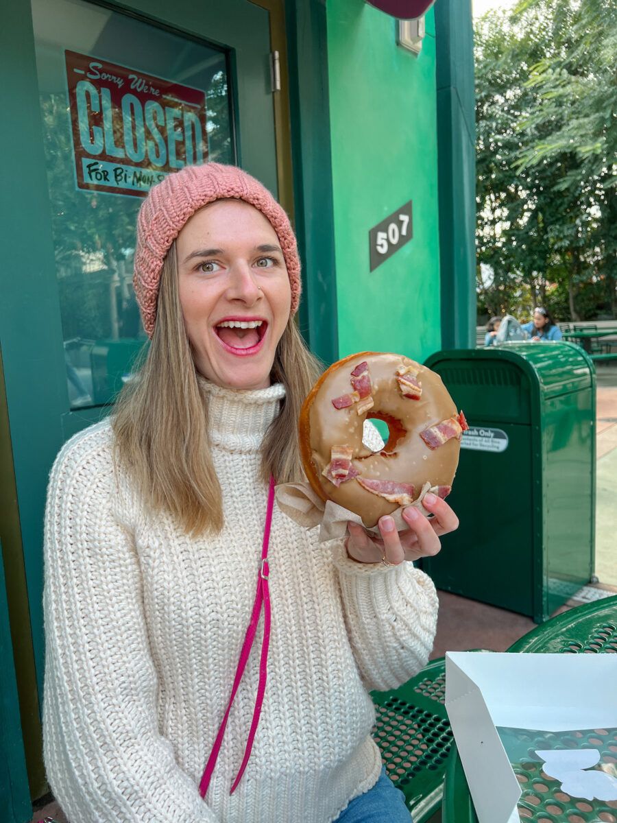 A photo of Mimi eating a huge donut at Universal Studios Hollywood in Los Angeles.