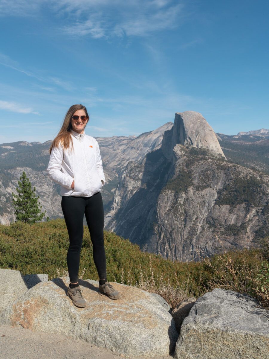 A photo of Mimi in front of Glacier point in Yosemite National Park, California.