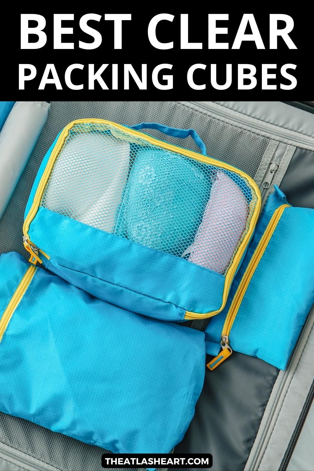 A close-up view of a set of three blue packing cubes with a mesh window, nestled inside of an open suitcase, with the text overlay, "Best Clear Packing Cubes."