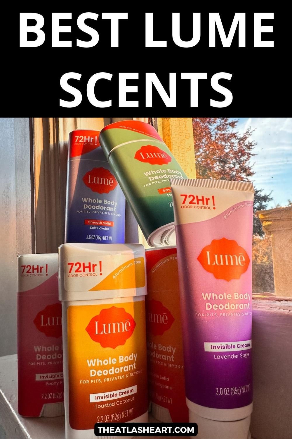 A stack of Lume deodorants in various scents, stacked on a windowsill, with a blue sky and autumn leaves visible through the pane, with the text overlay, "Best Lume Scents."