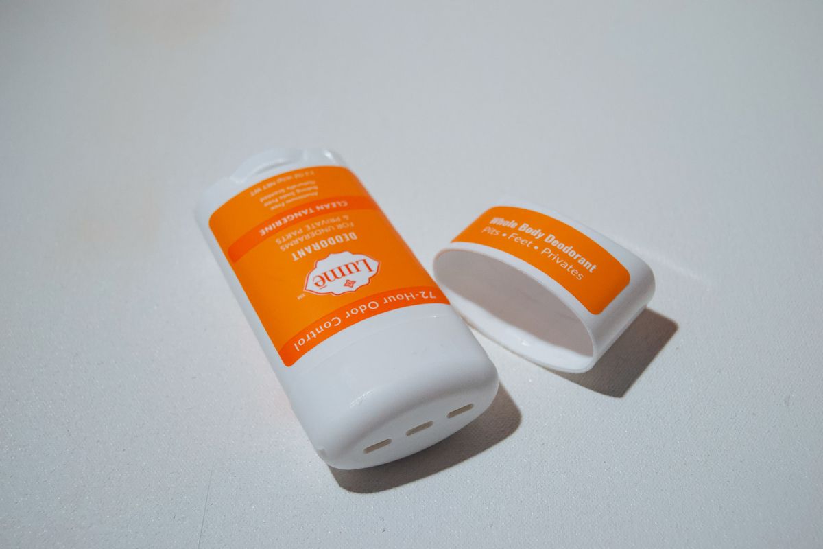 A stick of Clean Tangerine Lume deodorant sitting on a white background.