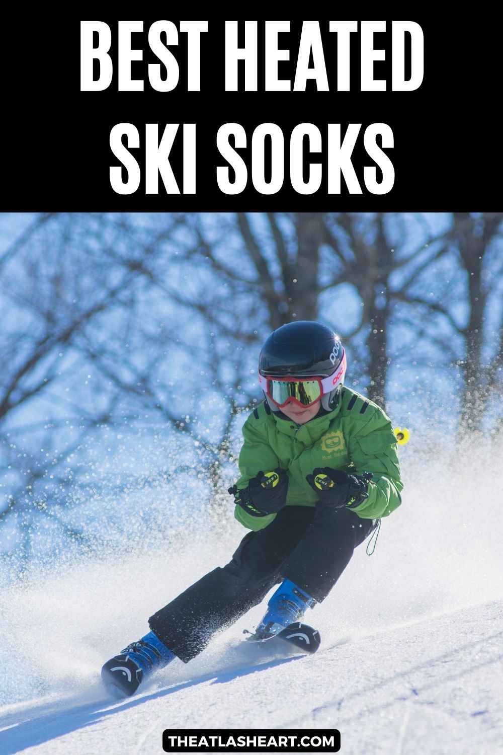 A young boy in a green ski jacket skis down a snowy hillside on a sunny day, with the text overlay, "Best Heated Ski Socks."