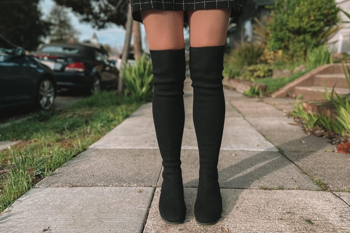 A close up of the black Madeline 2.0 over-the-knee winter boots on a winter day in the Bay Area.