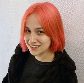 Elina Ansary with pink hair, wearing black.